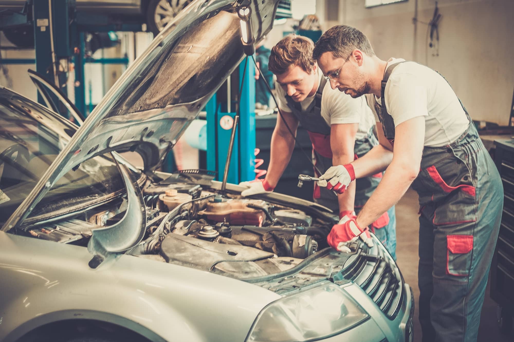 two-mechanics-fixing-car-in-a-workshop-2021-08-26-16-21-06-utc (1) (1)